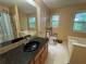 Bathroom featuring a bathtub and shower combination, window, and sink at 134 Summer Lake Dr, Dallas, GA 30157