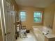 Bathtub and toilet combo with window and view at 134 Summer Lake Dr, Dallas, GA 30157