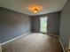 Comfortable bedroom featuring neutral walls, a window for natural light, and standard ceiling light fixture at 134 Summer Lake Dr, Dallas, GA 30157