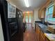Galley kitchen featuring dark countertops, wood cabinets and black appliances at 134 Summer Lake Dr, Dallas, GA 30157