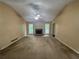 Expansive living room featuring a cozy fireplace, two large windows, and a ceiling fan for added comfort at 134 Summer Lake Dr, Dallas, GA 30157