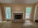Living room showcasing a stone fireplace, flanked by two large windows providing ample natural light at 134 Summer Lake Dr, Dallas, GA 30157