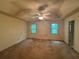 Large main bedroom featuring two windows and a ceiling fan at 134 Summer Lake Dr, Dallas, GA 30157