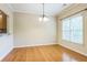 Bright dining area with hardwood floors and a view of the backyard through a large window at 1666 Oakbrook Lake Dr, Norcross, GA 30093