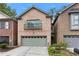 Charming brick home with a two-car garage and Juliet balcony offers curb appeal at 1666 Oakbrook Lake Dr, Norcross, GA 30093