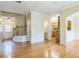 Open-concept living space with hardwood floors, leading to the staircase, kitchen, and half bathroom at 1666 Oakbrook Lake Dr, Norcross, GA 30093