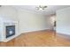Spacious living room with hardwood floors, a fireplace, and a glimpse of the staircase at 1666 Oakbrook Lake Dr, Norcross, GA 30093