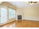 Comfortable living room featuring hardwood floors, a fireplace, and access to a patio at 1666 Oakbrook Lake Dr, Norcross, GA 30093
