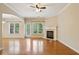 Bright living room with hardwood floors, fireplace, and access to the outdoor patio at 1666 Oakbrook Lake Dr, Norcross, GA 30093