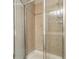 Tiled shower features glass doors and modern fixtures at 1666 Oakbrook Lake Dr, Norcross, GA 30093