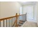 A carpeted stairway showcasing the dark metal spindles and a stained wood banister at 1666 Oakbrook Lake Dr, Norcross, GA 30093