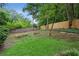 Green backyard with mature trees, grass, and a wooden fence at 1680 Bristol Ne Dr, Atlanta, GA 30329