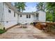 Backyard wooden deck featuring a dining table, outdoor seating, and a grill at 1680 Bristol Ne Dr, Atlanta, GA 30329