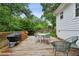 Backyard wooden deck featuring a grill, dining table, and outdoor seating at 1680 Bristol Ne Dr, Atlanta, GA 30329