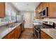 Galley kitchen with stainless steel appliances, granite counters, and wooden cabinetry at 1680 Bristol Ne Dr, Atlanta, GA 30329
