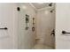 Modern walk-in shower with neutral tile, built-in shelving, and bronze fixtures at 1680 Bristol Ne Dr, Atlanta, GA 30329