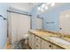 Bright bathroom features a granite countertop, dual sinks, a large mirror, and updated fixtures at 2750 Briarfield Way, Lawrenceville, GA 30043