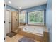 Bathroom with natural light, shower, soaking tub and tile flooring at 2750 Briarfield Way, Lawrenceville, GA 30043