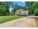 Long driveway leading to this two-story home in a quiet, wooded lot at 2750 Briarfield Way, Lawrenceville, GA 30043