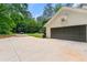 Side view of a well-maintained, two-car garage with long driveway at 2750 Briarfield Way, Lawrenceville, GA 30043