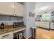 Additional counter space in kitchen area with granite countertop and stainless-steel trash receptacle at 2750 Briarfield Way, Lawrenceville, GA 30043