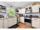 Functional kitchen with granite countertops, stainless steel appliances, and open shelving at 2750 Briarfield Way, Lawrenceville, GA 30043
