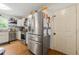 Well lit kitchen featuring stainless steel refrigerator, oven, dishwasher, white cabinets and hardwood floors at 2750 Briarfield Way, Lawrenceville, GA 30043