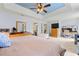 Spacious bedroom featuring natural light, tray ceiling and in-suite bath and work station at 2750 Briarfield Way, Lawrenceville, GA 30043