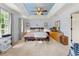 Spacious bedroom featuring natural light, tray ceiling with ceiling fan and light colored carpet at 2750 Briarfield Way, Lawrenceville, GA 30043