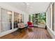 Charming sunroom with wood floors, comfortable seating, and views of the surrounding greenery at 2750 Briarfield Way, Lawrenceville, GA 30043