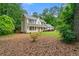 View of home with mature trees providing shade and privacy in the backyard at 2750 Briarfield Way, Lawrenceville, GA 30043