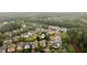Aerial view of neighborhood with mature trees, lush landscaping, and well-maintained homes at 4916 Gathering Pl, Suwanee, GA 30024