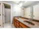 Bathroom featuring double vanity with wood cabinets and tiled shower at 4916 Gathering Pl, Suwanee, GA 30024