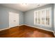 Neutral bedroom with hardwood floors, double door closet, and plantation shutters at 4916 Gathering Pl, Suwanee, GA 30024