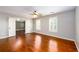 Spacious bedroom features hardwood floors, ceiling fan, and plantation shutters at 4916 Gathering Pl, Suwanee, GA 30024