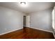 Bedroom with wood floors, a door and shuttered windows at 4916 Gathering Pl, Suwanee, GA 30024