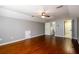Bonus room with wood floors, ceiling fan, white trim and an en suite at 4916 Gathering Pl, Suwanee, GA 30024