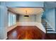 Dining room featuring hardwood floors, wainscoting, and a stylish light fixture at 4916 Gathering Pl, Suwanee, GA 30024