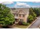 Beautiful two-story home with lush landscaping and mature trees creating curb appeal at 4916 Gathering Pl, Suwanee, GA 30024