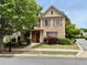 Charming brick home with a well-manicured lawn and a welcoming red front door at 4916 Gathering Pl, Suwanee, GA 30024