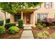 Inviting entrance with a brick facade, trimmed shrubs, and a well-maintained lawn at 4916 Gathering Pl, Suwanee, GA 30024