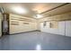 Spacious garage with epoxy floor, shelving and ample storage cabinets at 4916 Gathering Pl, Suwanee, GA 30024