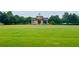 Expansive green space featuring a decorative gateway structure, perfect for community events or relaxation at 4916 Gathering Pl, Suwanee, GA 30024