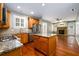 Open kitchen with granite countertops, stainless steel appliances, and a central island at 4916 Gathering Pl, Suwanee, GA 30024