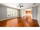 Spacious living room with hardwood floors, large window, and elegant architectural details at 4916 Gathering Pl, Suwanee, GA 30024
