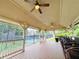 Covered pavilion with ceiling fans overlooks a tennis court, providing a shady spot for spectators at 4916 Gathering Pl, Suwanee, GA 30024
