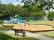 Community playground featuring swings, slides and climbing area offers fun for children in a well-maintained area at 4916 Gathering Pl, Suwanee, GA 30024