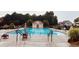 Community swimming pool with lounge chairs and tables, surrounded by greenery and seating at 4916 Gathering Pl, Suwanee, GA 30024