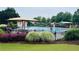 Community pool with shaded seating areas, lounge chairs, and well-maintained landscaping at 4916 Gathering Pl, Suwanee, GA 30024