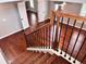 Staircase featuring natural wood steps, black wrought iron spindles and a wood banister at 4916 Gathering Pl, Suwanee, GA 30024